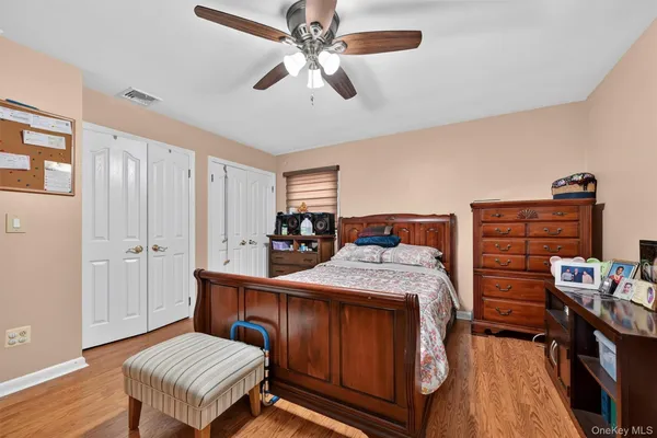 a bedroom with bed and flat screen tv