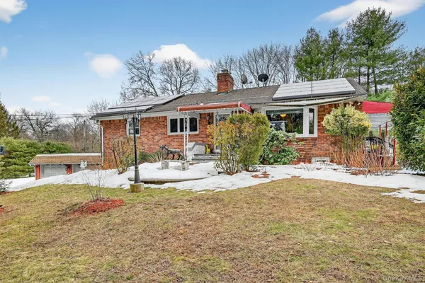a living room with furniture ceiling fan and a flat screen tv