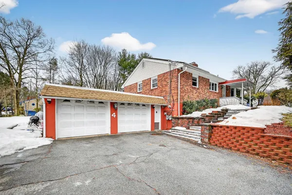 a kitchen with stainless steel appliances granite countertop a refrigerator a stove and a sink with wooden floor