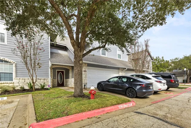 a view of a car parked in front of a house