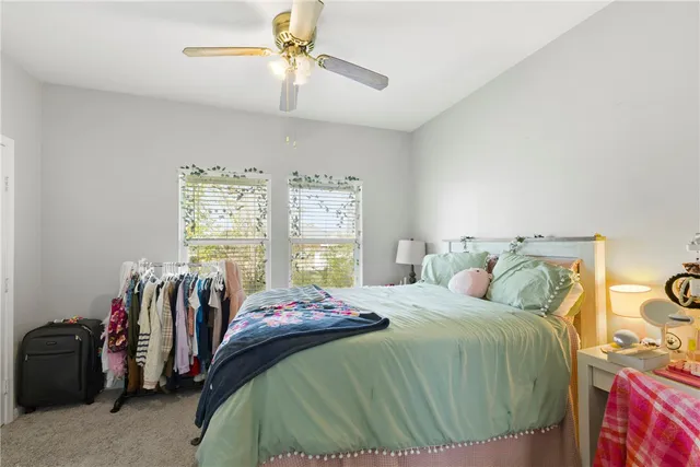 a bedroom with a large bed and a window