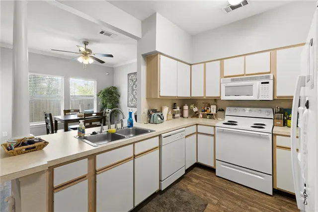 a bathroom with a sink vanity mirror and toilet