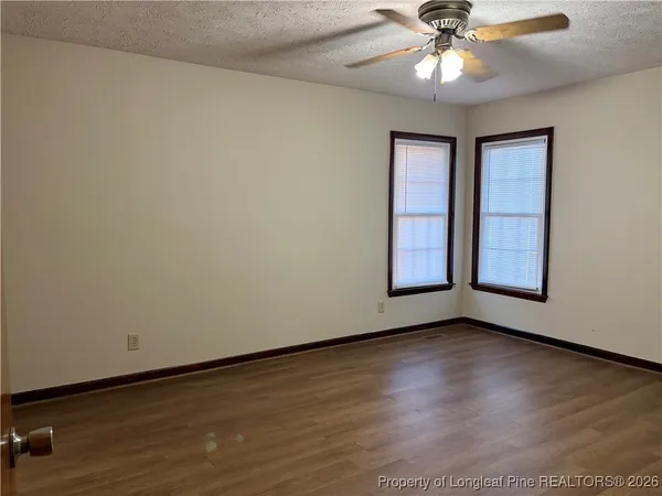 an empty room with closet and wooden floor