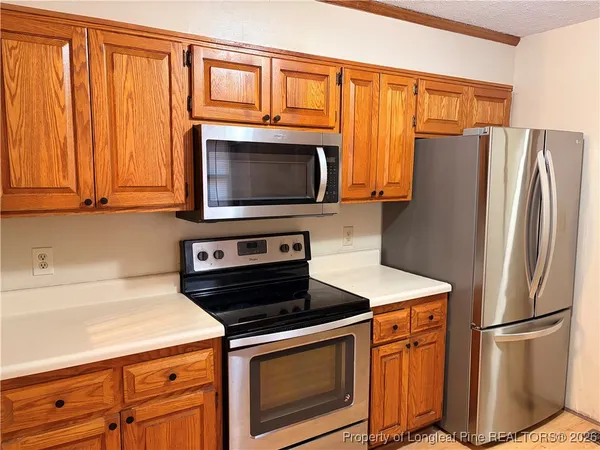 a kitchen with wooden cabinets and a sink