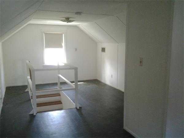 161 Mayflower Road Springfield, MA 01118 - Photo 14 of 20 an empty room with wooden floor cabinet and windows
