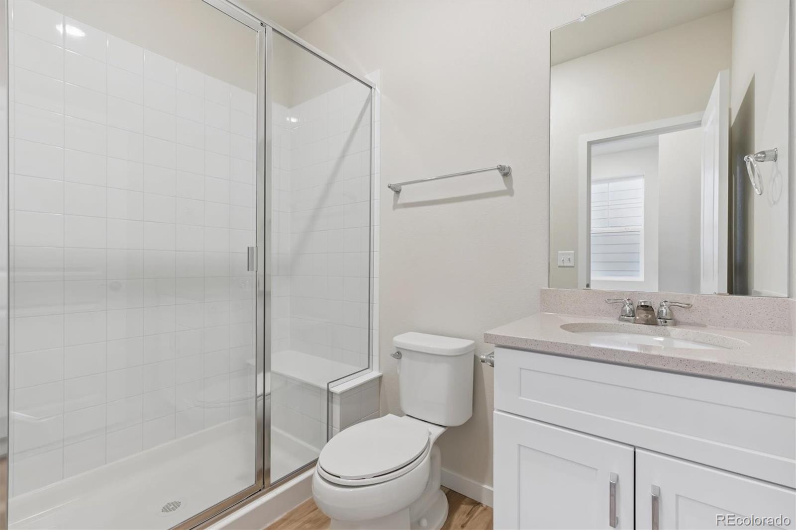 1430 Farmstead Street Brighton, CO 80601 - Photo 12 of 24 a bathroom with a sink a toilet and shower