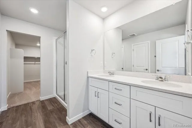 a bathroom with a double vanity sink and mirror