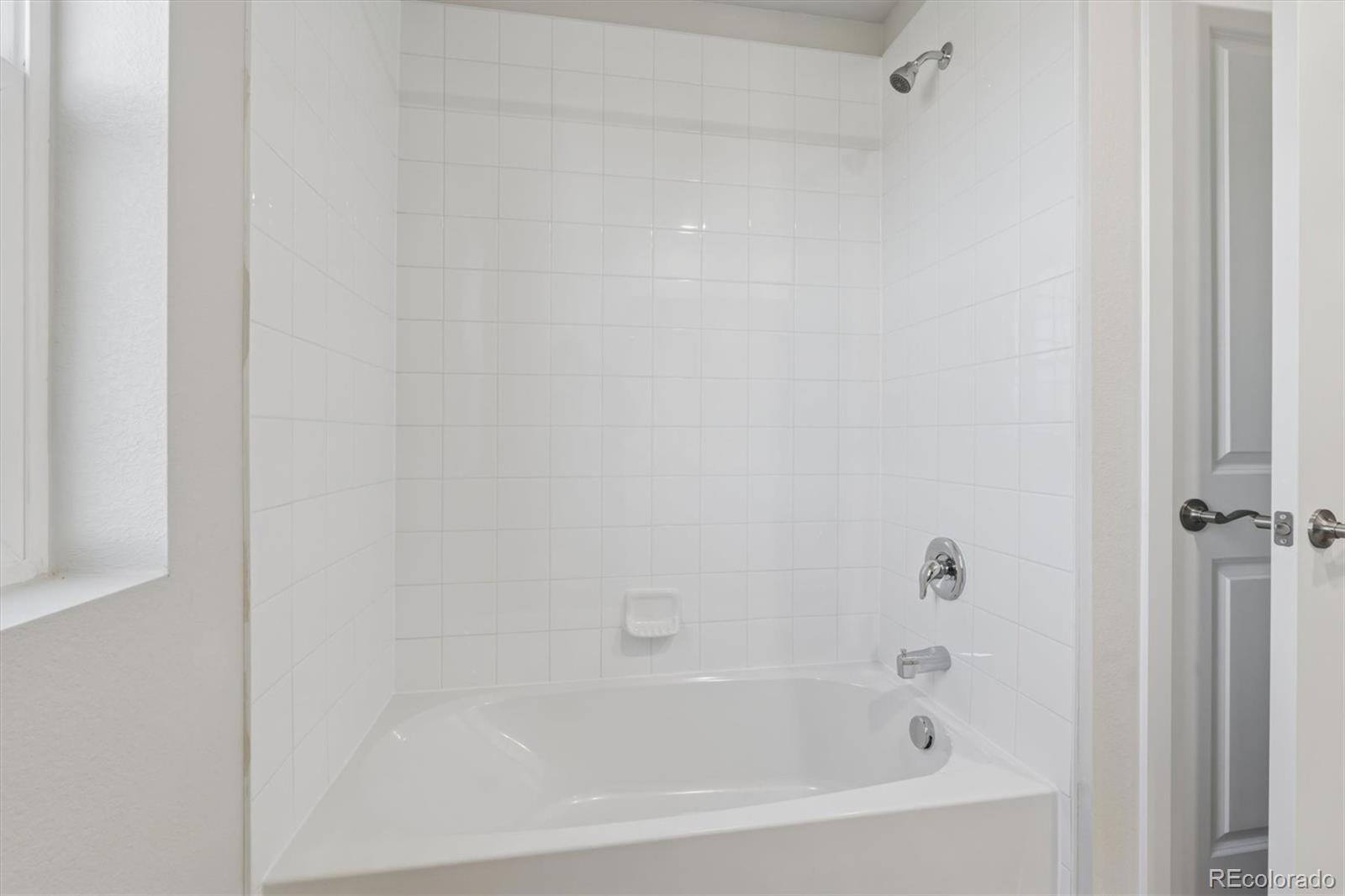 1430 Farmstead Street Brighton, CO 80601 - Photo 17 of 24 a bathroom with a bathtub