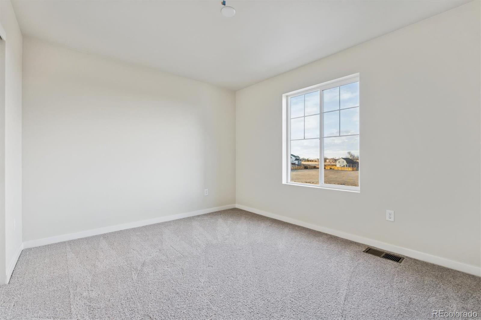 1430 Farmstead Street Brighton, CO 80601 - Photo 18 of 24 an empty room with a window