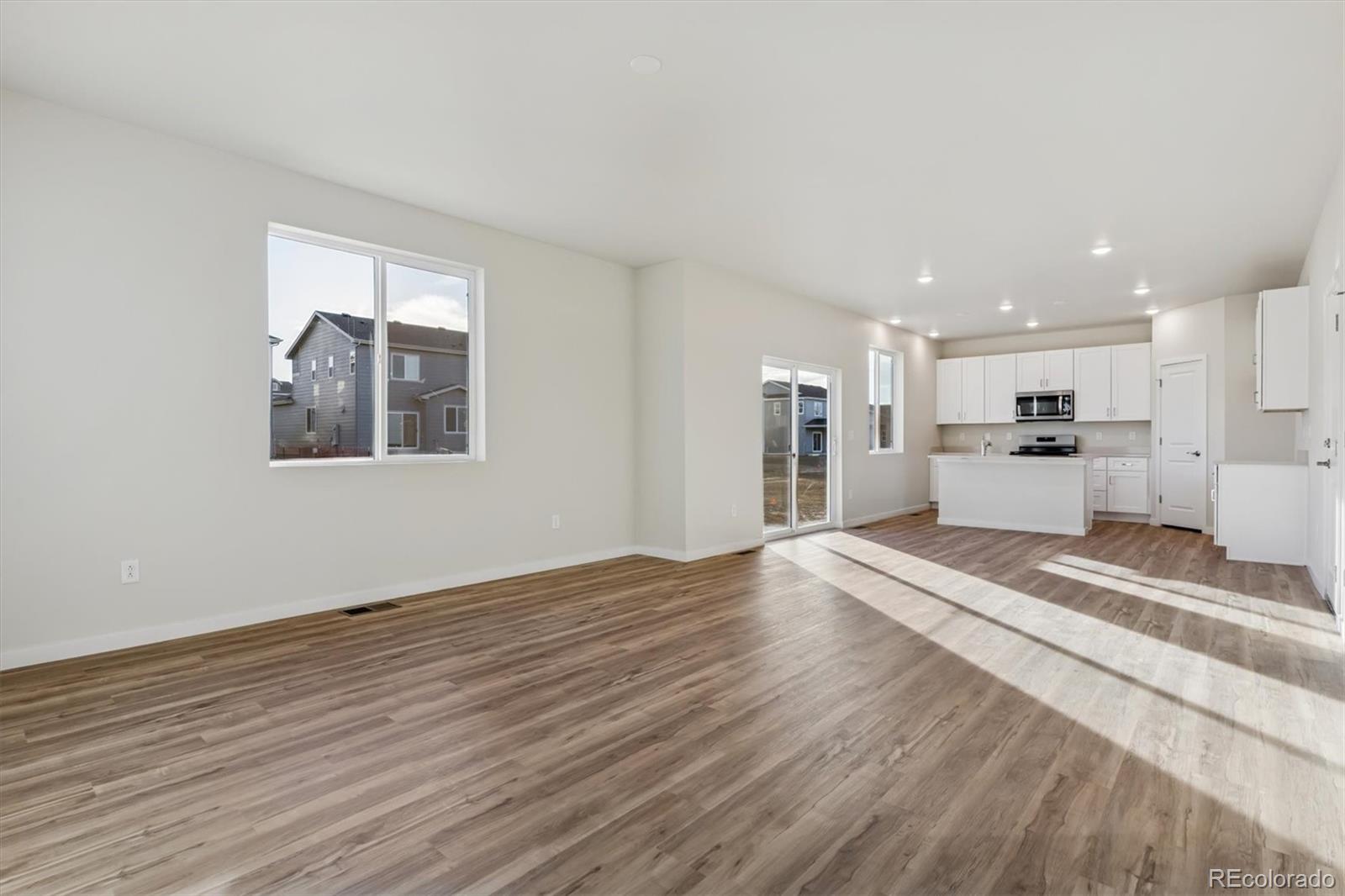 1430 Farmstead Street Brighton, CO 80601 - Photo 2 of 24 a view of a kitchen with a sink and a stove top oven