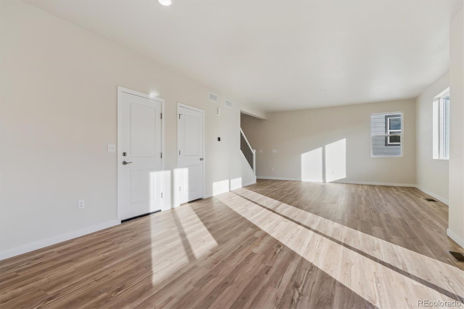1430 Farmstead Street Brighton, CO 80601 - Photo 4 of 24 a spacious bedroom with a bed and a window