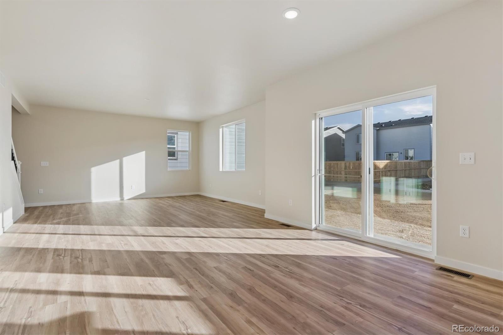 1430 Farmstead Street Brighton, CO 80601 - Photo 5 of 24 a view of room with wooden floor and window
