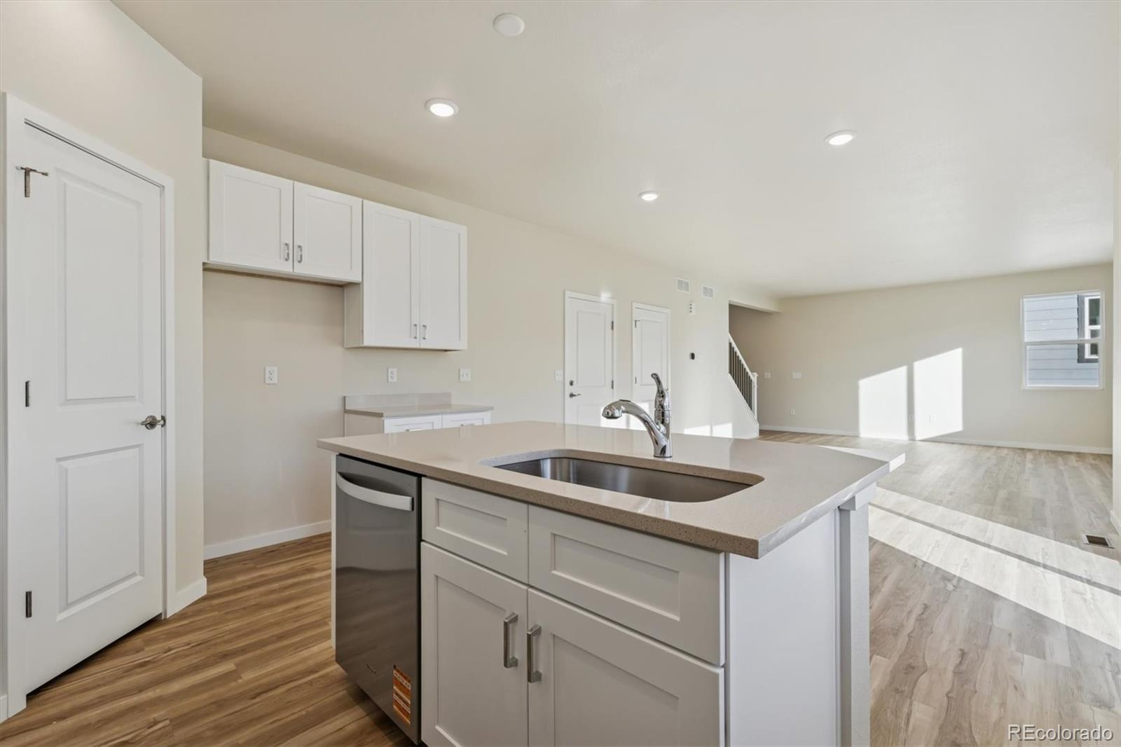 1430 Farmstead Street Brighton, CO 80601 - Photo 8 of 24 a kitchen with a sink and cabinets
