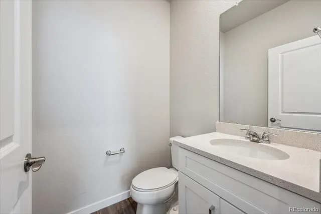 a bathroom with a sink toilet and a mirror