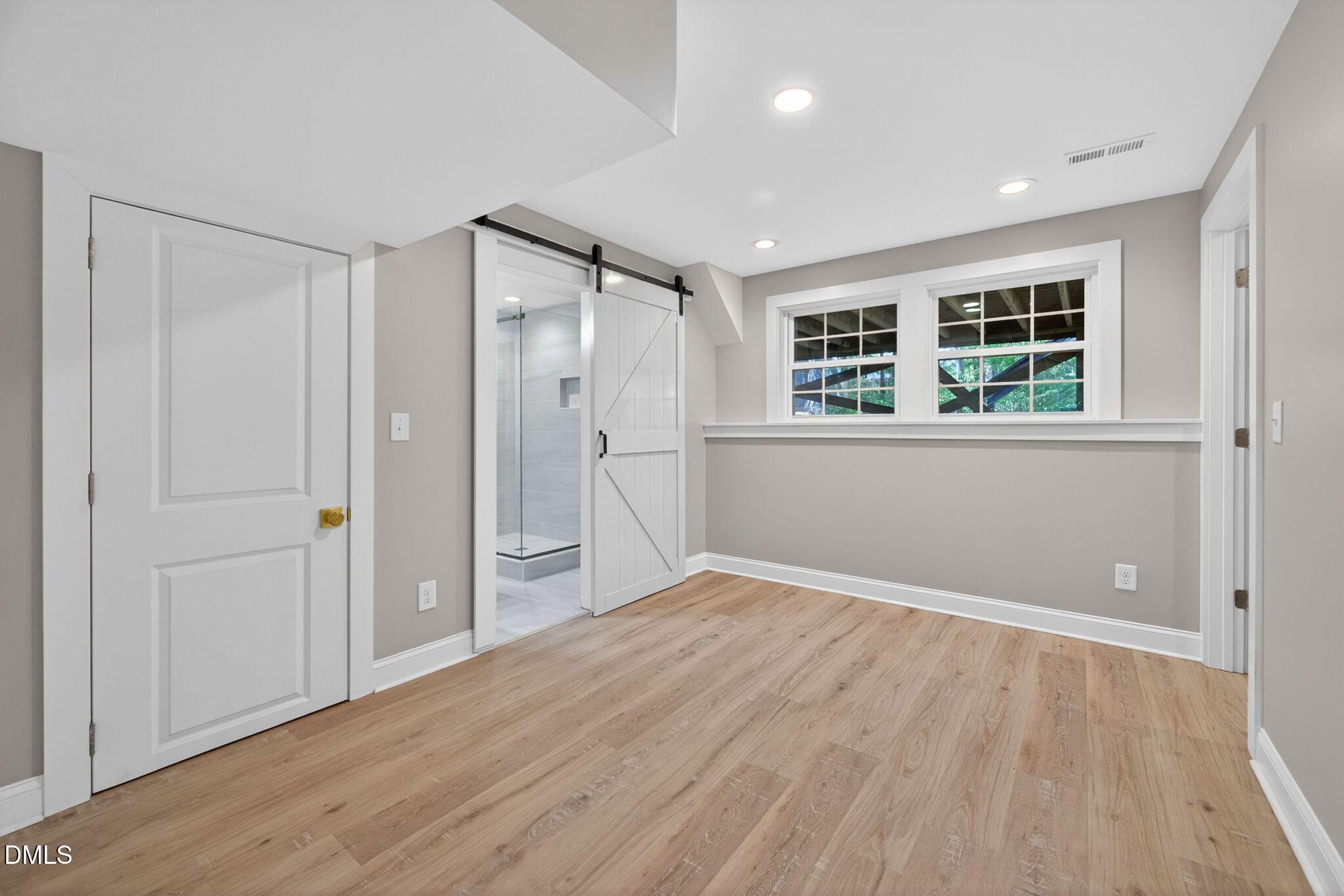 313 Crown Oaks Drive Raleigh, NC 27615 - Photo 29 of 60 wooden floor in an empty room with a window