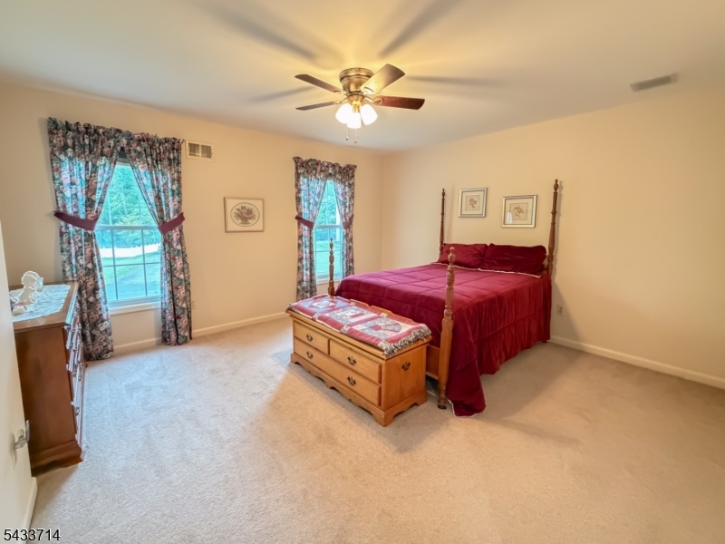 29 Lark Lane Oak Ridge, NJ 07438 - Photo 18 of 26 a living room with a bed and a chandelier