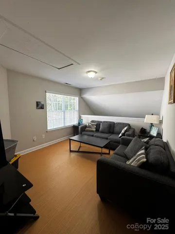 a front view of a house with a garden and trees