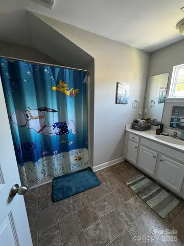 front view of a house with swimming pool and a yard