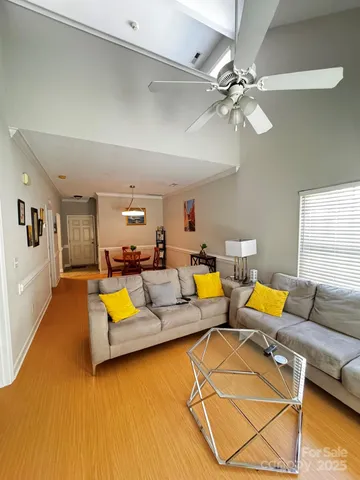a living room with furniture and kitchen view