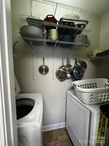 a living room with a bed furniture and a flat screen tv