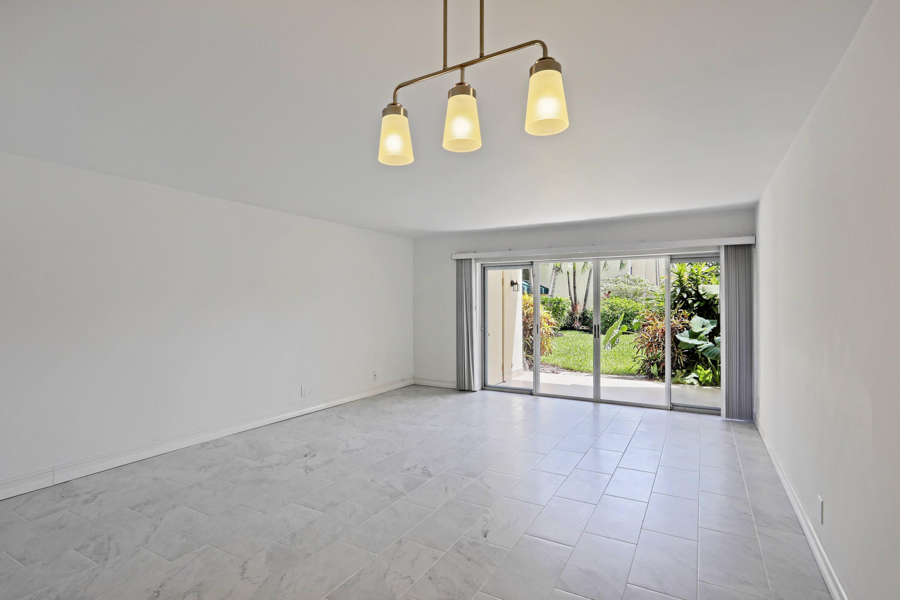 394 Golfview Road, Unit F North Palm Beach, FL 33408 - Photo 11 of 73 wooden floor in an empty room with a window