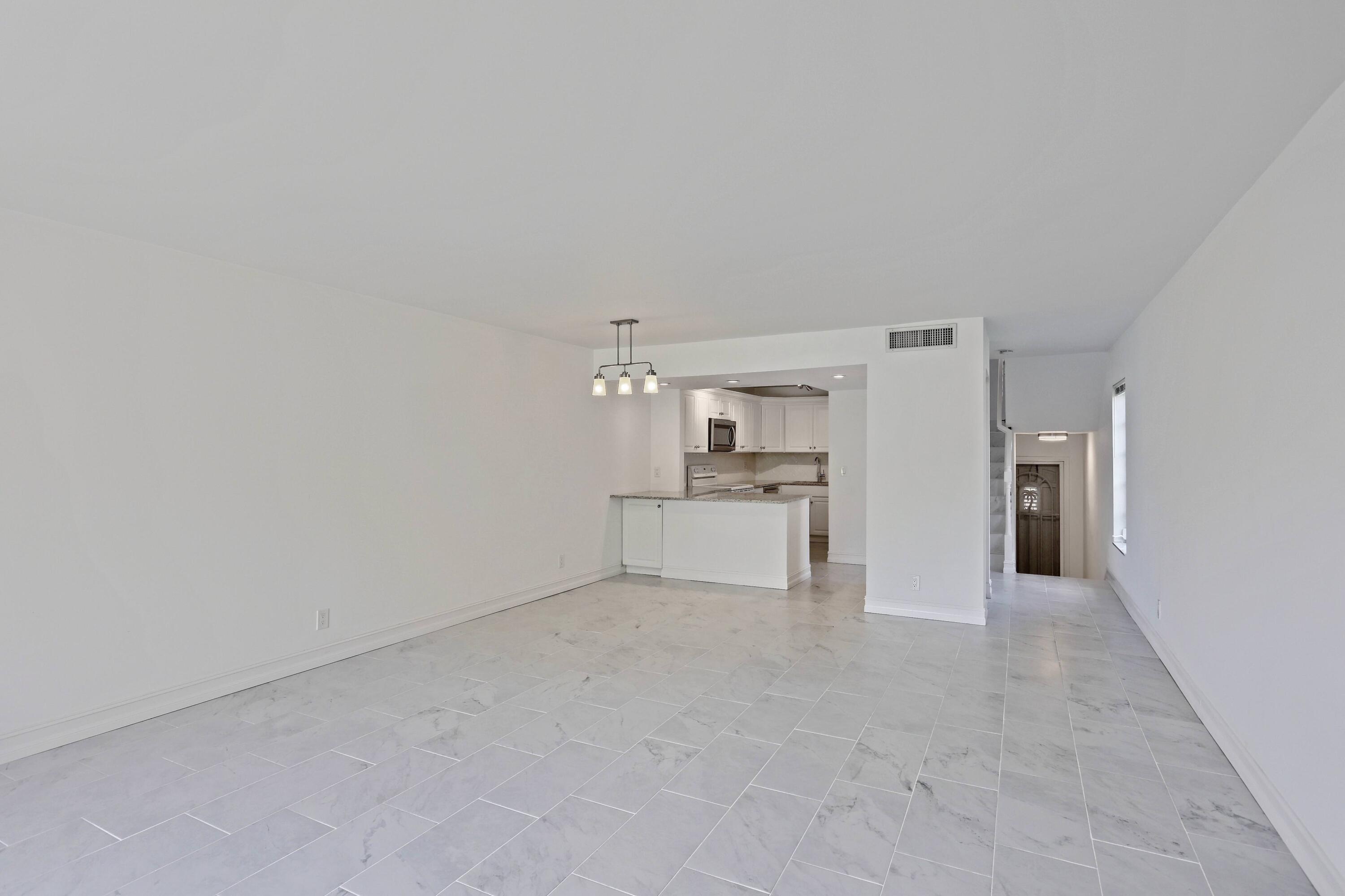 394 Golfview Road, Unit F North Palm Beach, FL 33408 - Photo 13 of 73 a view of a kitchen with refrigerator and cabinets