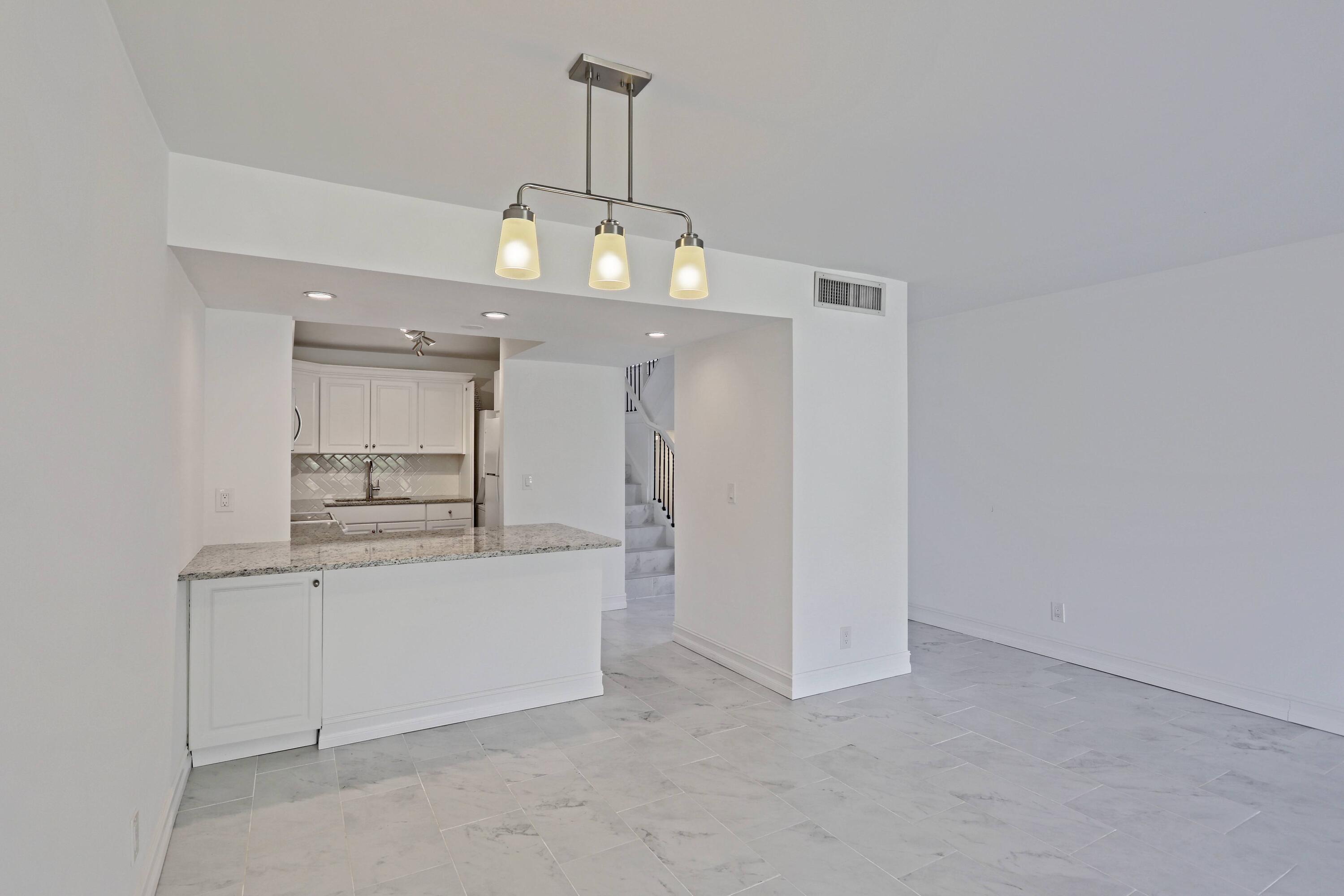 394 Golfview Road, Unit F North Palm Beach, FL 33408 - Photo 15 of 73 a view of a kitchen with a sink and dishwasher a refrigerator freezer