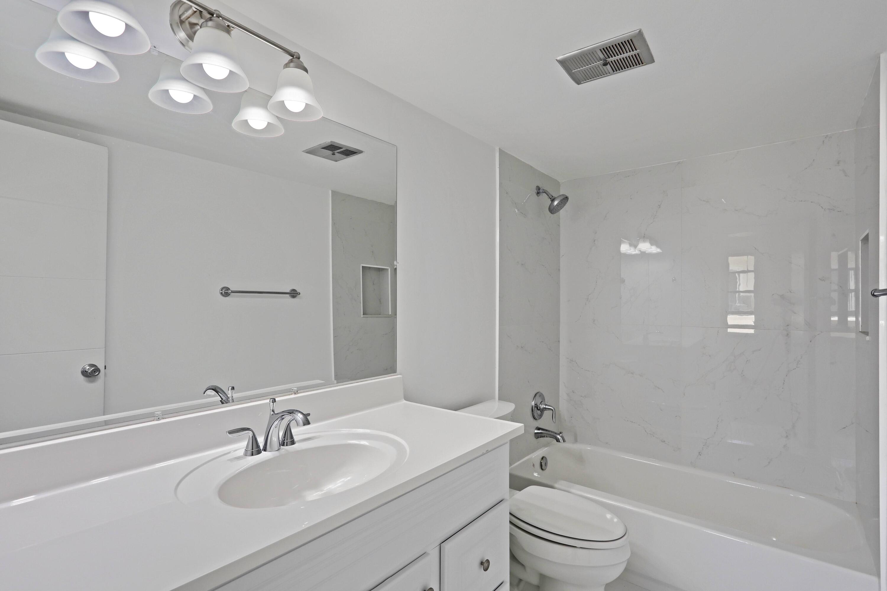 394 Golfview Road, Unit F North Palm Beach, FL 33408 - Photo 25 of 73 a bathroom with a sink a toilet and shower