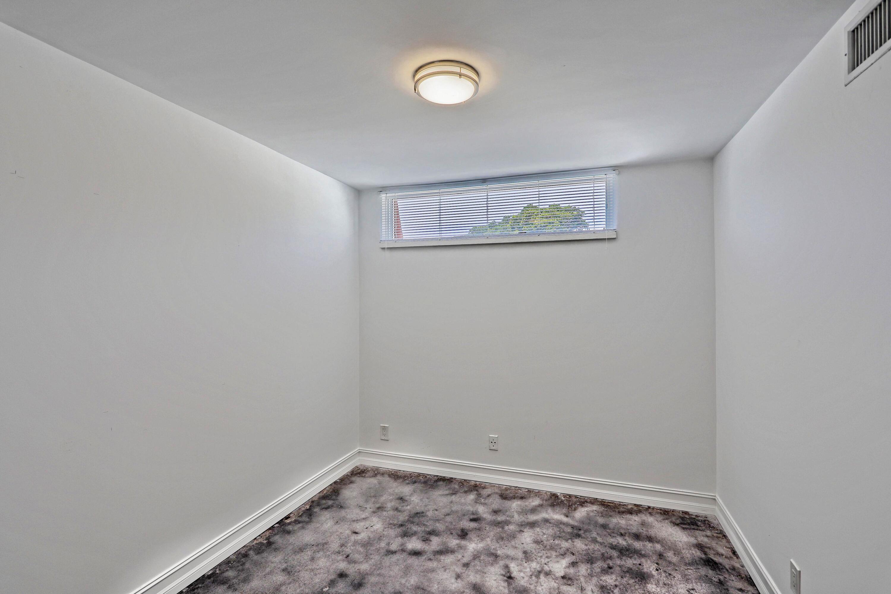 394 Golfview Road, Unit F North Palm Beach, FL 33408 - Photo 27 of 73 a view of a room with an empty space and a window