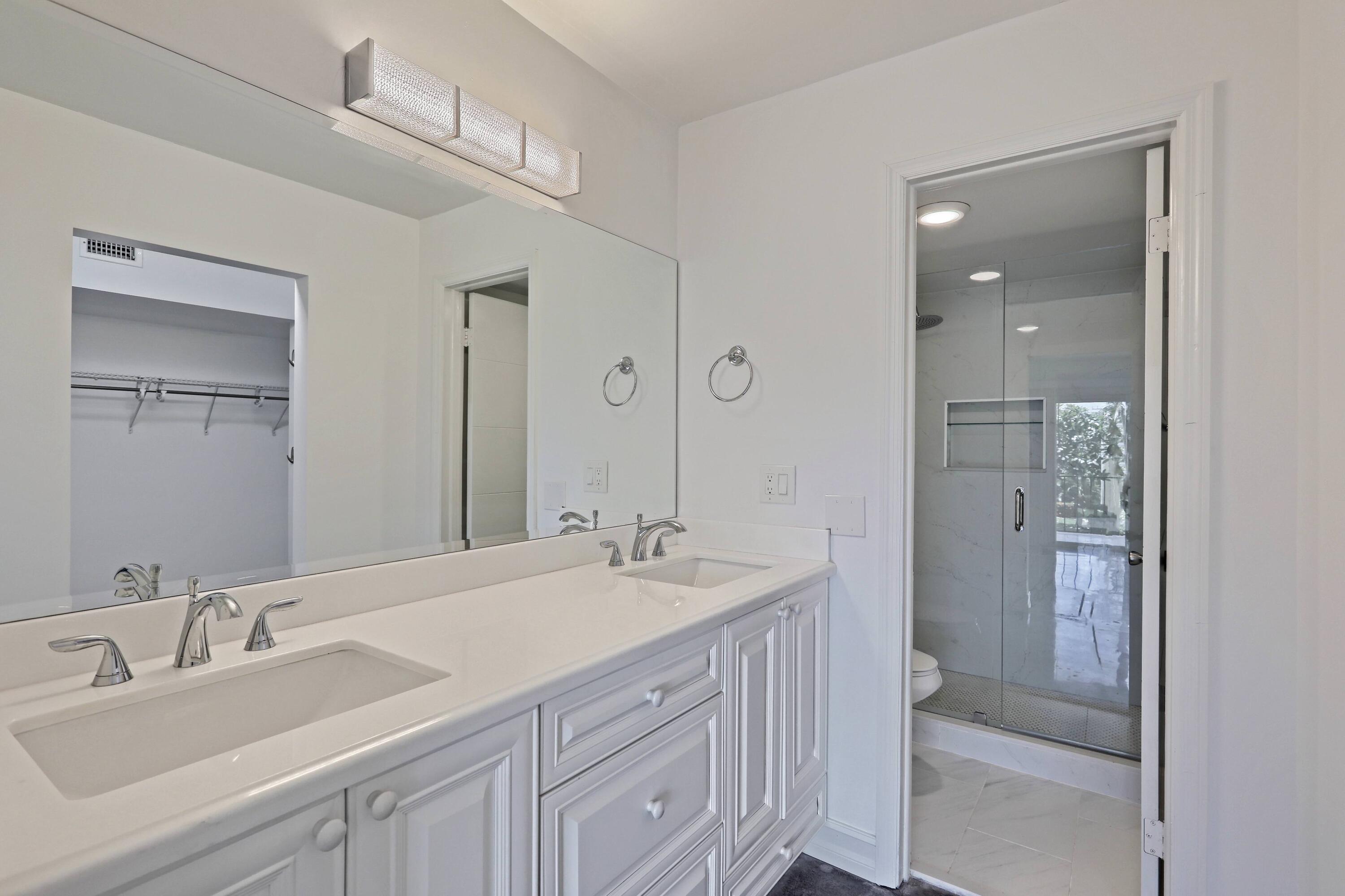 394 Golfview Road, Unit F North Palm Beach, FL 33408 - Photo 30 of 73 a bathroom with a double vanity sink mirror and double
