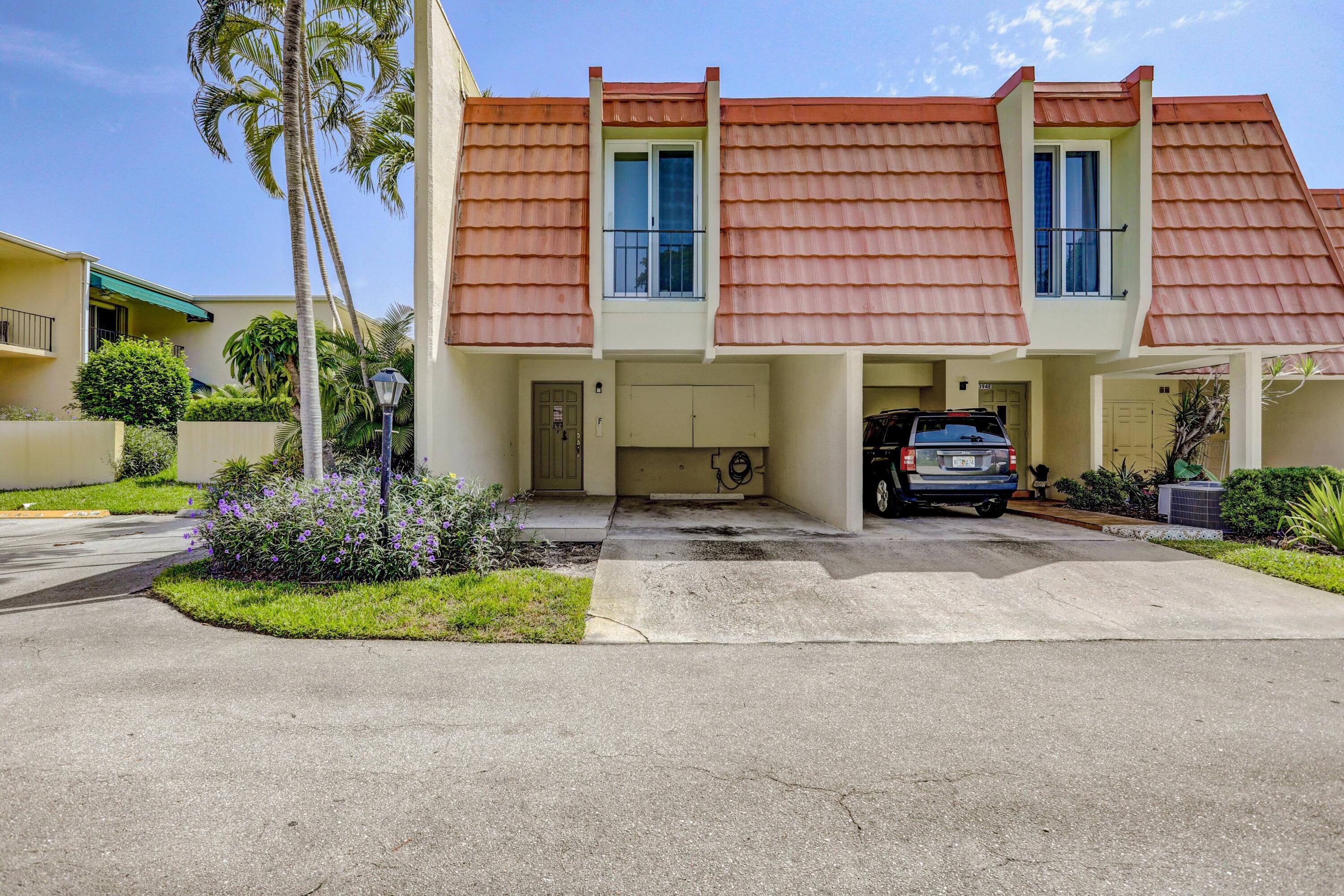 394 Golfview Road, Unit F North Palm Beach, FL 33408 - Photo 3 of 73 a front view of a building with garden