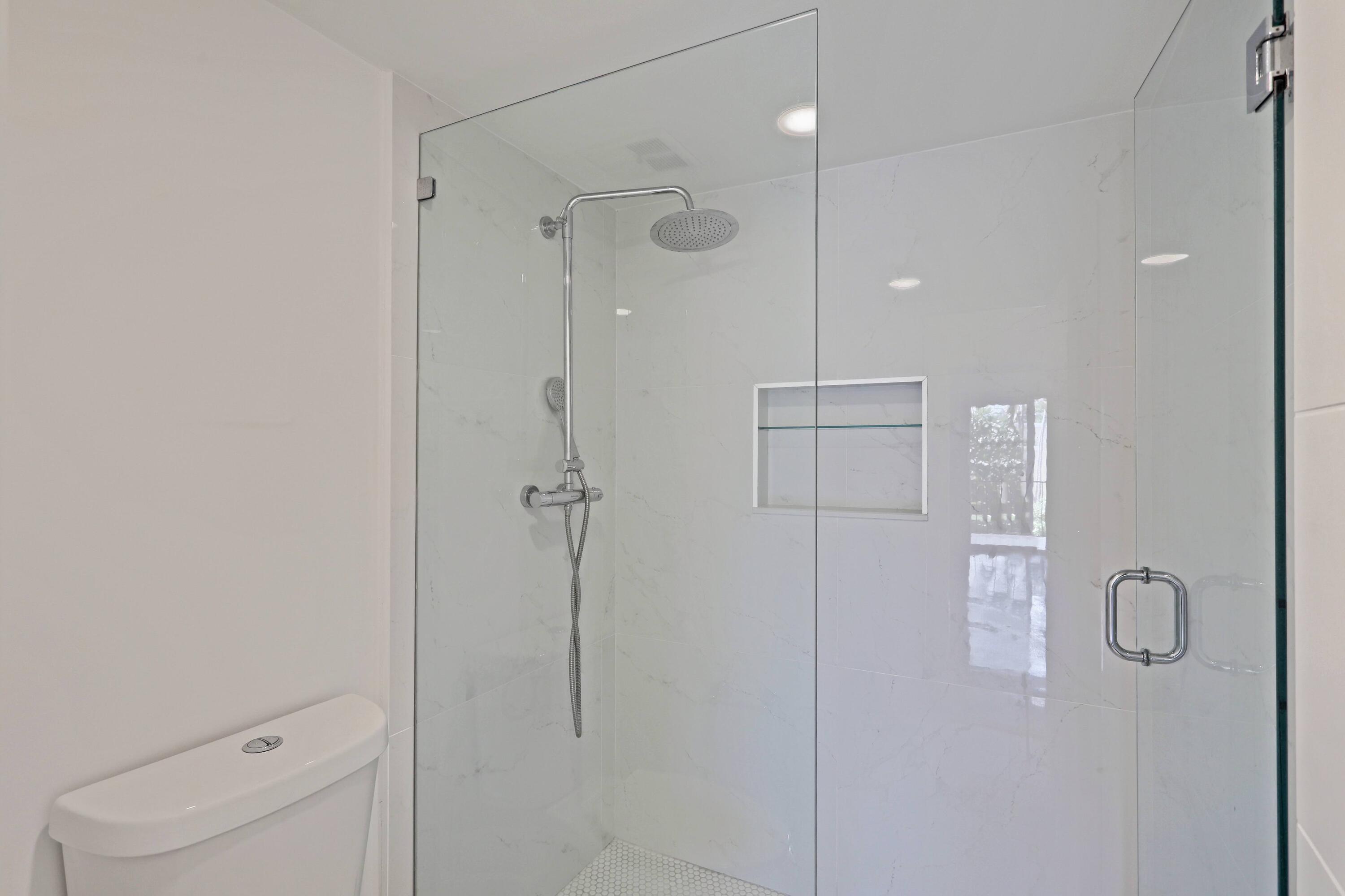394 Golfview Road, Unit F North Palm Beach, FL 33408 - Photo 32 of 73 a bathroom with a shower and a toilet