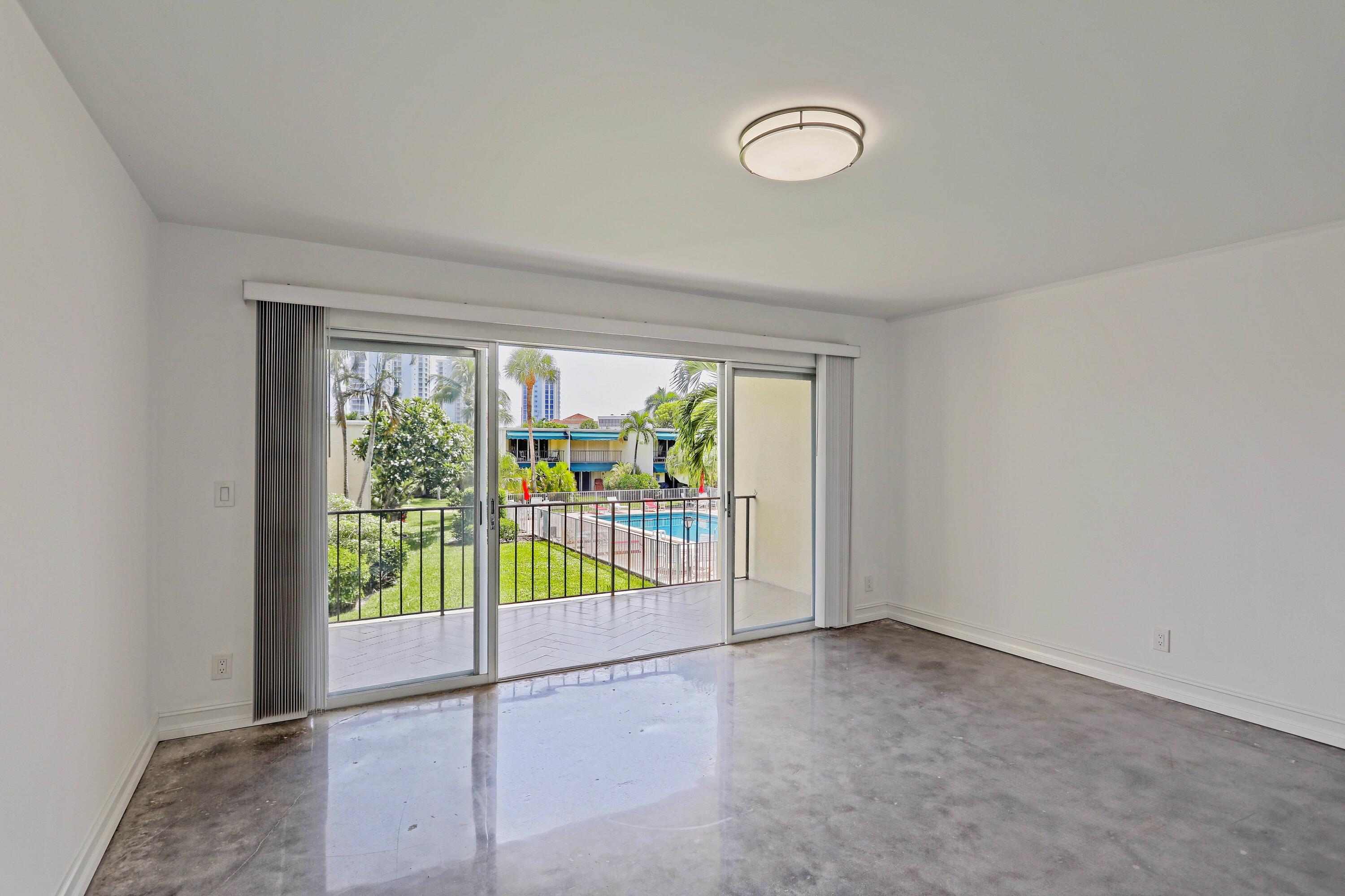 394 Golfview Road, Unit F North Palm Beach, FL 33408 - Photo 34 of 73 a view of a room with sliding glass door