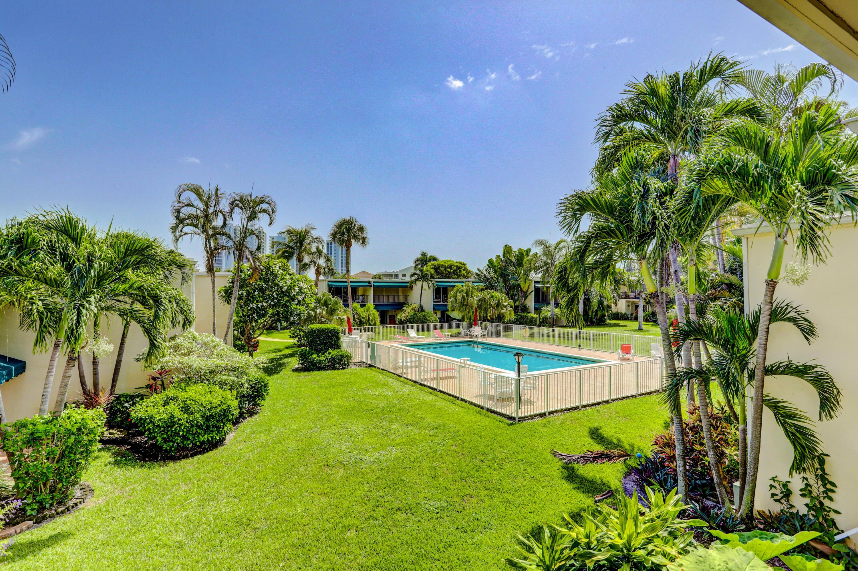 394 Golfview Road, Unit F North Palm Beach, FL 33408 - Photo 38 of 73 a view of a backyard with plants and a garden