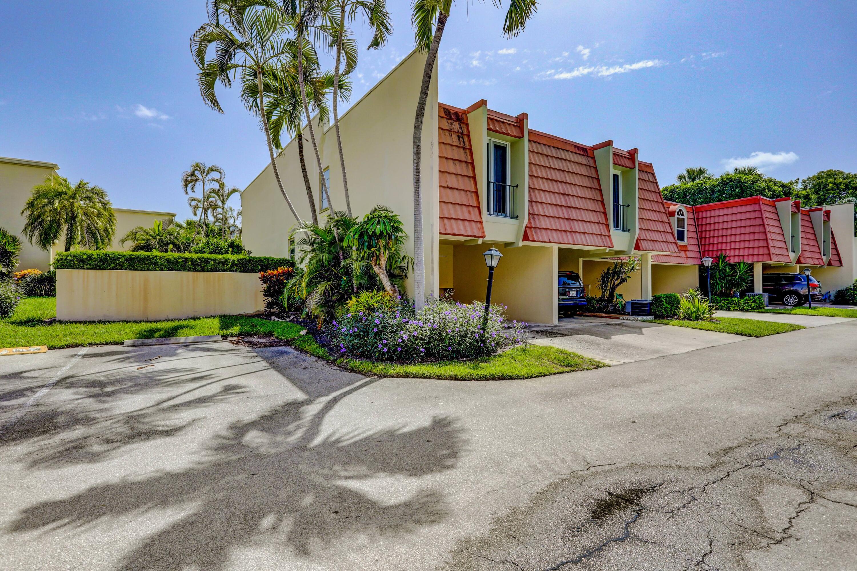 394 Golfview Road, Unit F North Palm Beach, FL 33408 - Photo 5 of 73 a front view of a house with a yard and outdoor seating