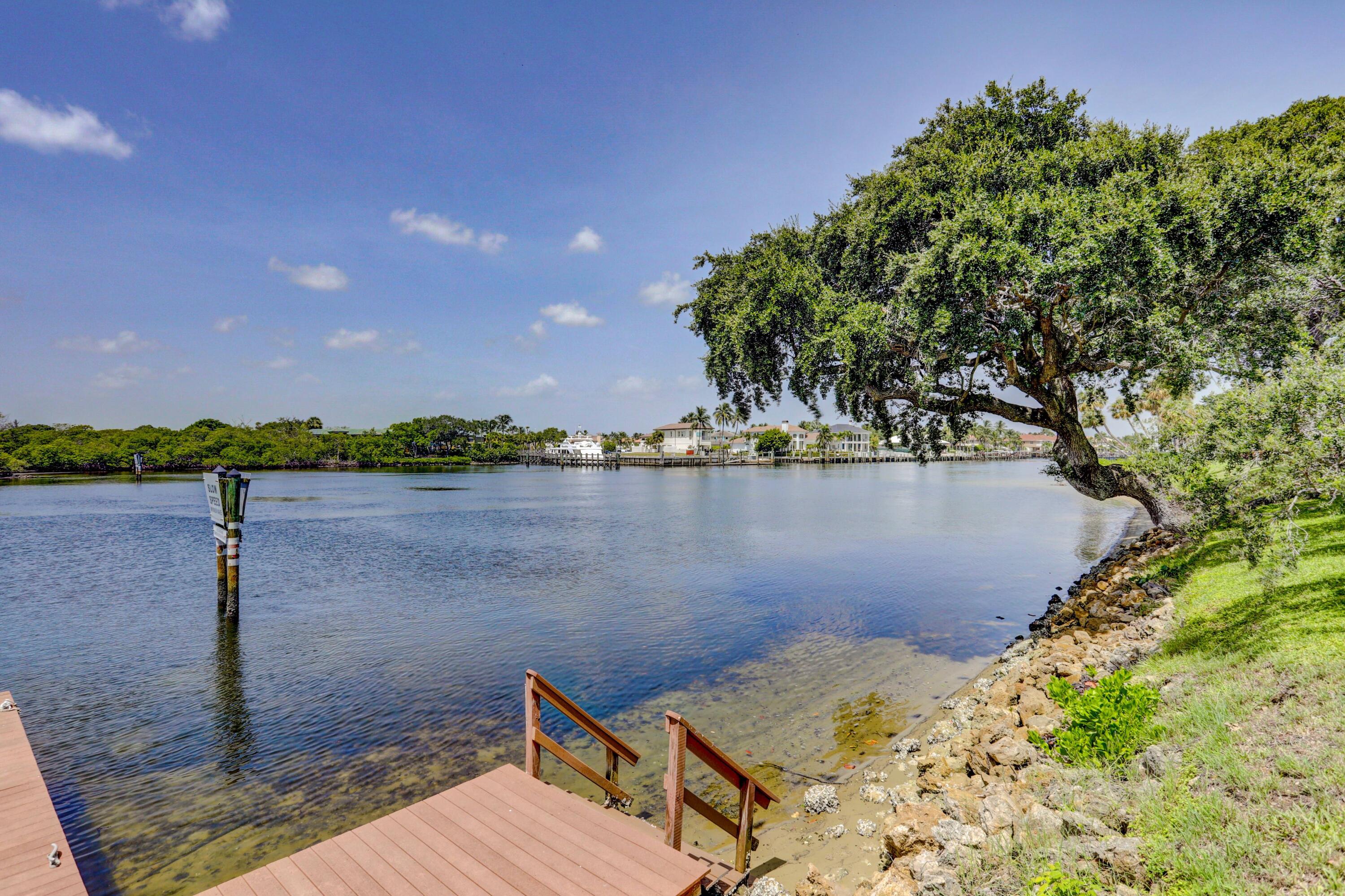 394 Golfview Road, Unit F North Palm Beach, FL 33408 - Photo 52 of 73 a view of a lake with a house in the background