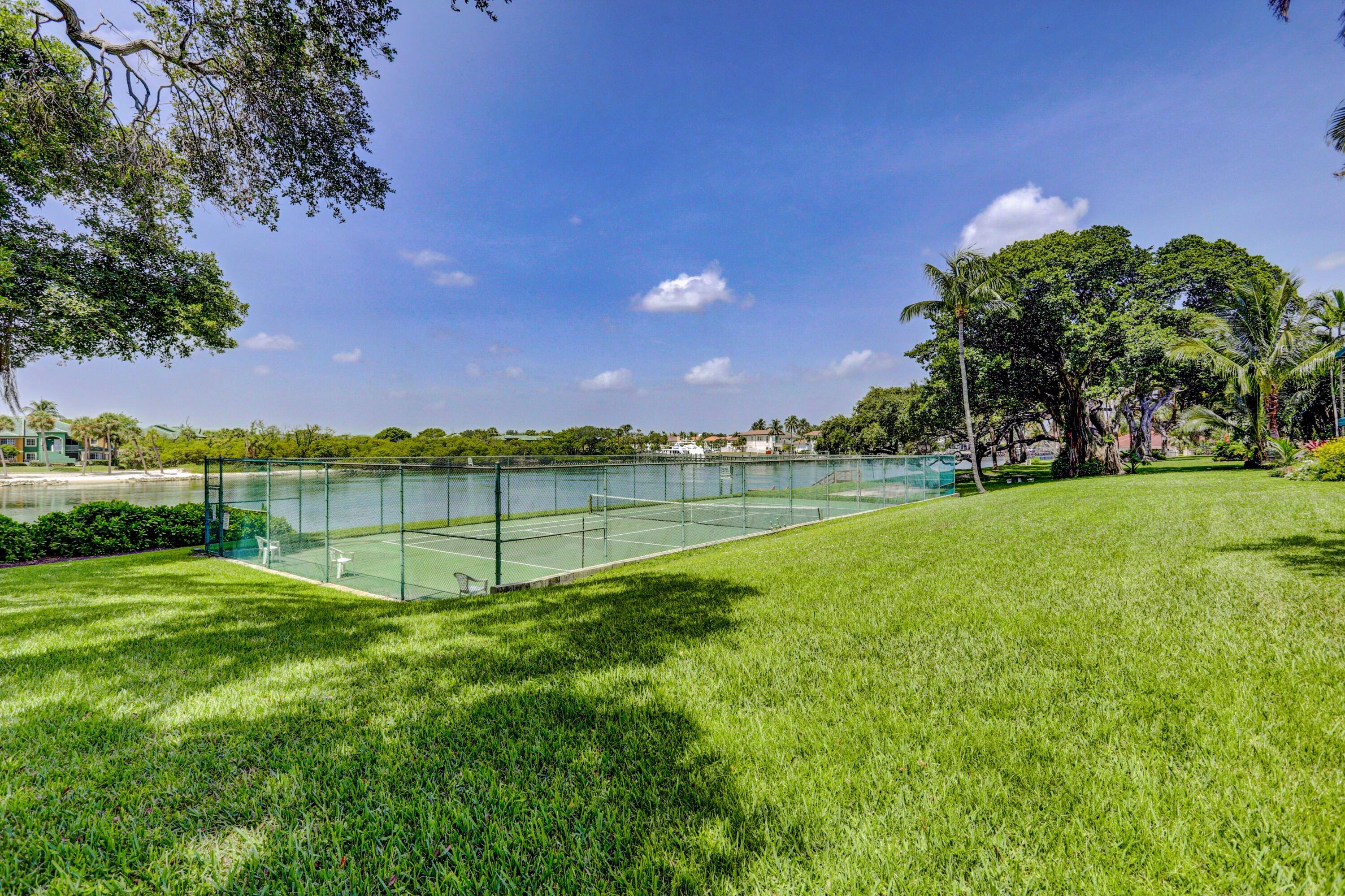 394 Golfview Road, Unit F North Palm Beach, FL 33408 - Photo 57 of 73 a view of a garden with a building in the background