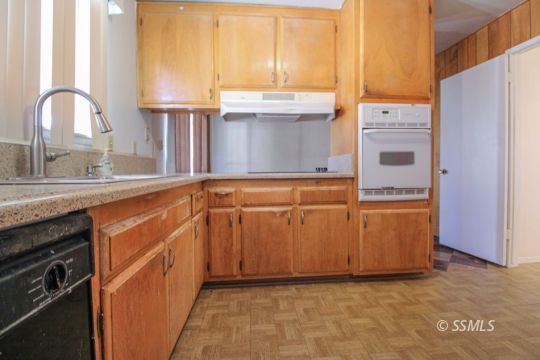 537 South Fairview Street Ridgecrest, CA 93555 - Photo 8 of 35 a kitchen with granite countertop a sink a stove and refrigerator