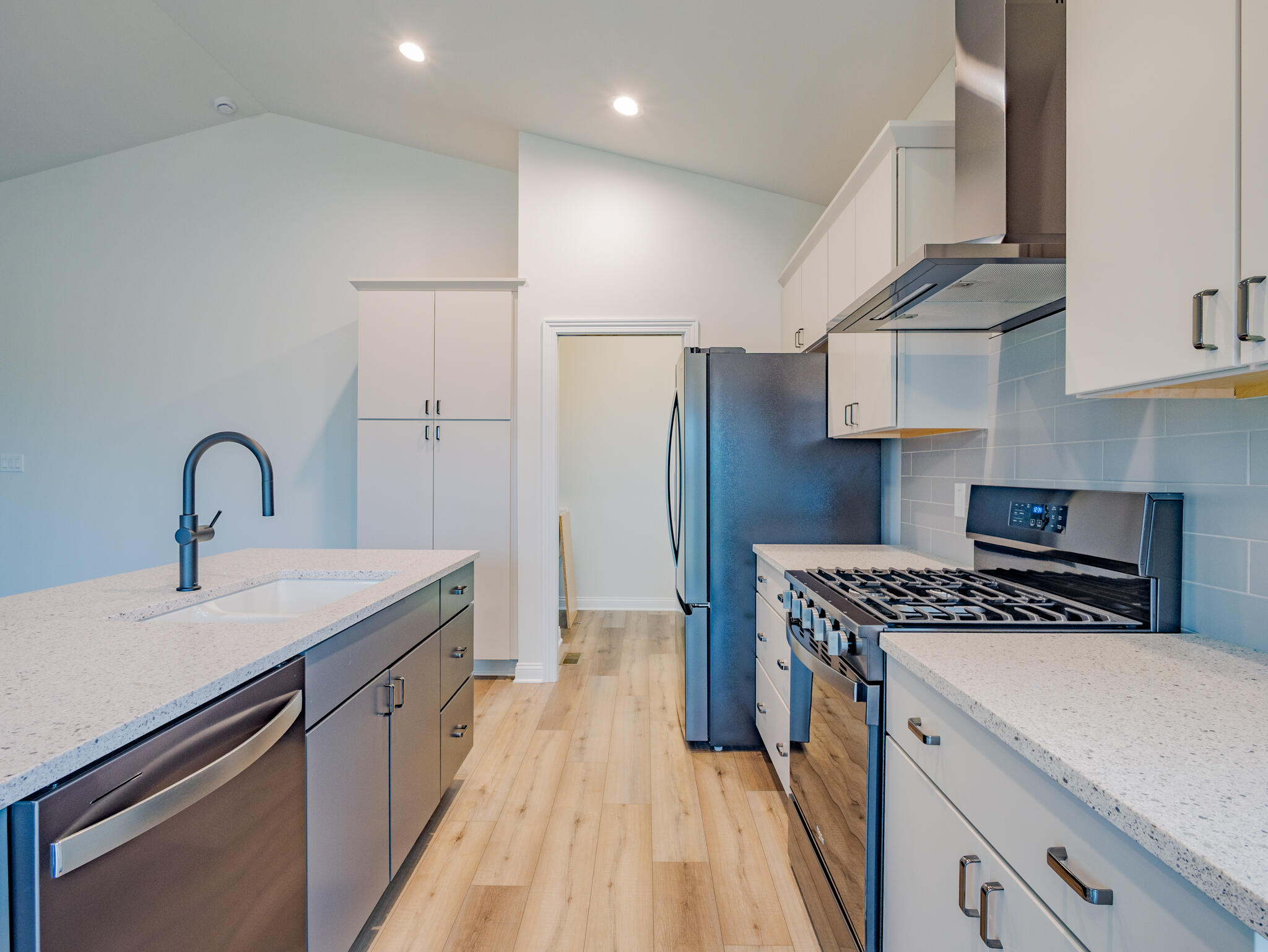 3004 Forestside Lane Valparaiso, IN 46385 - Photo 13 of 23 a kitchen with stainless steel appliances a sink dishwasher stove refrigerator and cabinets with wooden floor