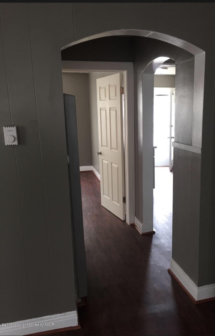 3531-3529 South Harrison Street Amarillo, TX 79110 - Photo 19 of 30 a view of a hallway with wooden floor