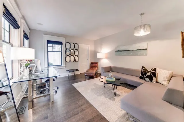 a living room with furniture rug and window