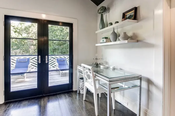 a large white kitchen with a large window and stainless steel appliances