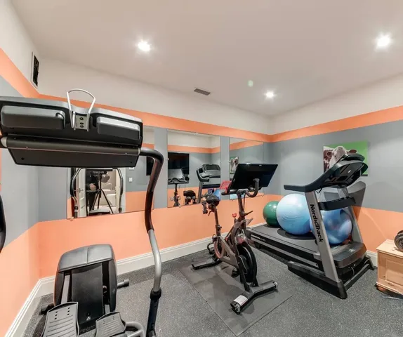 a bedroom with a bed and a lamp with the dresser