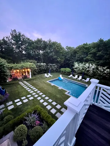a view of a garden with lawn chairs
