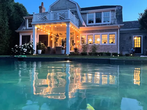 a view of swimming pool with a yard and plants