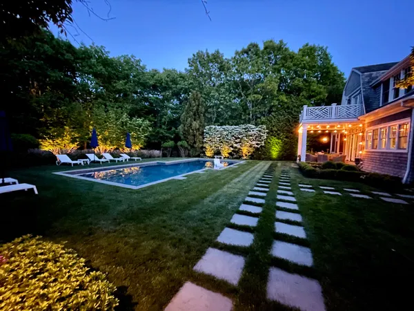 a view of a lake with a yard and sitting area