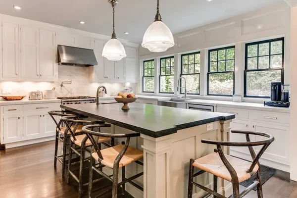 a kitchen with a table chairs sink and cabinets