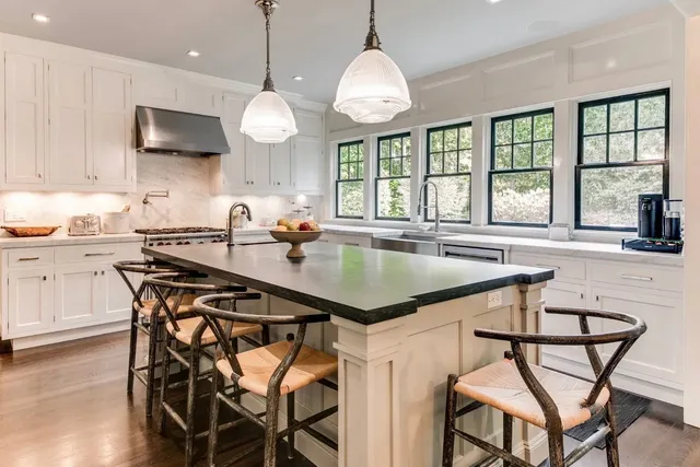 a kitchen with a table chairs sink and cabinets