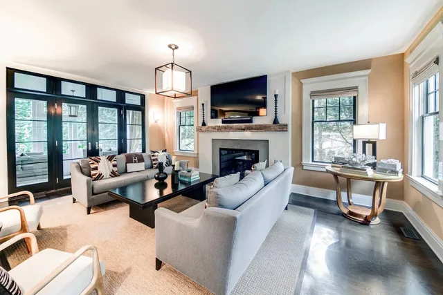 a living room with fireplace furniture and a flat screen tv