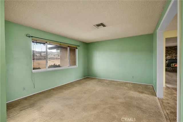 an empty room with a window and doors